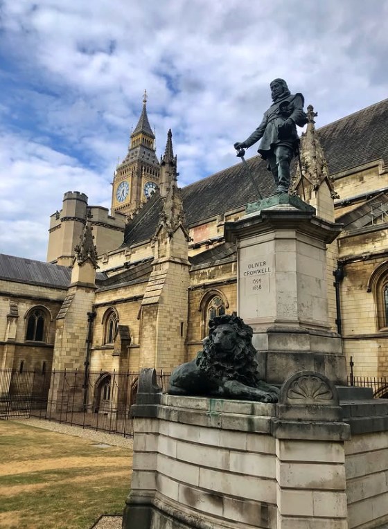 The bronze statue of Oliver
Cromwell on Cromwell Green, a lion at the foot of its plinth and the Elizabeth Tower behind